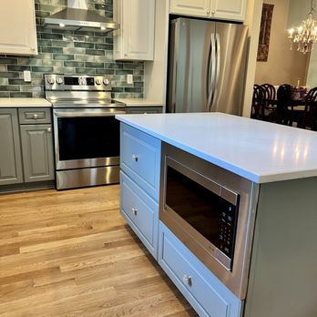 U. R. Construction - When relocating the microwave into the island, a built in trim kit is the key to a sleek look. - General Contractors Near Me