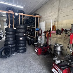 A&J Tire Service - The inside of the shop with selection of tires and some of the equipment.