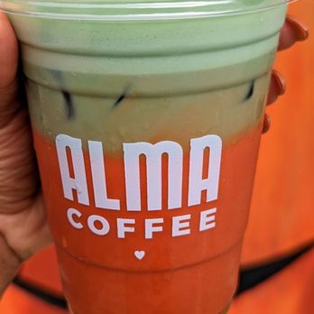 Alma Coffee - a hand holding a cup of coffee - Coffee & Tea Near Me - Canton, Georgia