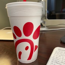 ows a paper cup with a red paw print on it