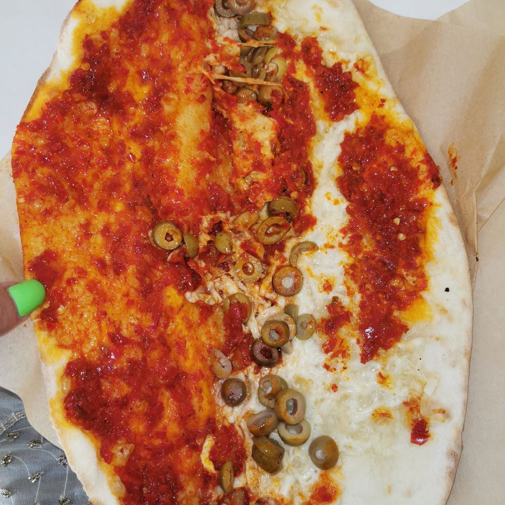Le Pain Saj Express - a pizza with olives and cheese - Pizza Near Me - Laval, Quebec