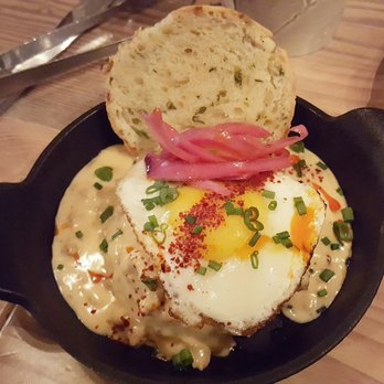 Lechon - 4th plate: jalapeño biscuit with chorizo gravy, sunny egg, and marinated onion. - Tapas Bars Near Me - Portland, Oregon