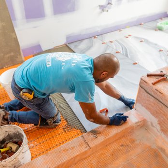 Broadway Tile Company - a man laying tile on the floor - General Contractors Near Me - Long Beach, New York Broadway Tile Company - a man laying tile on the floor - General Contractors Near Me - Long Beach, New York