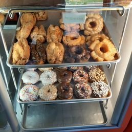 a variety of donuts in a display case a variety of donuts in a display case