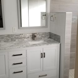 J J 'll Do It - This is a bathroom remodel that we did. New vanity installation and new tile floor, also a new shower remodel.