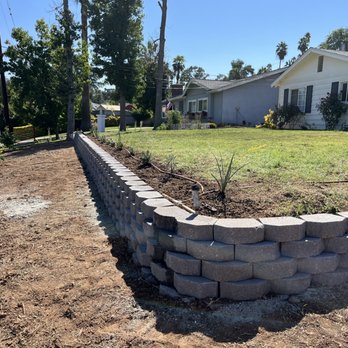 Ready For You Landscaping services - Finished retaining wall with plants, drip system and 3 citrus trees planted in front. - Landscaping Near Me - Banning, California