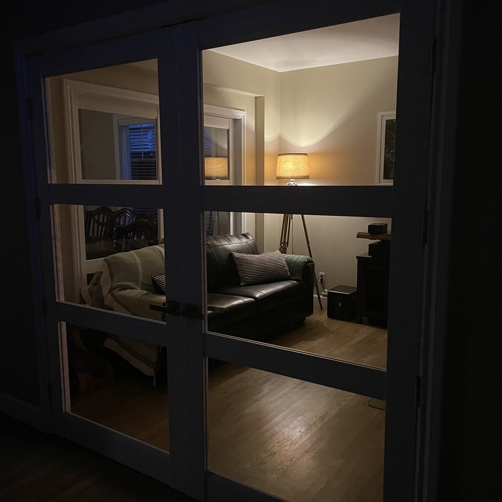 JZ Landscape & Const - a view of a living room through a glass door - Landscaping Near Me JZ Landscape & Const - a view of a living room through a glass door - Landscaping Near Me