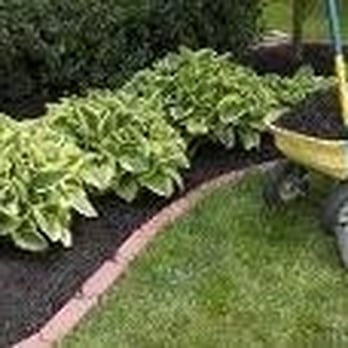 Suburban Landscaping - a wheelbarrow in a garden - Landscaping Near Me - Dudley, Massachusetts