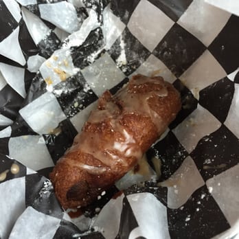 The Donut Kitchen - Sweet potato batter dipped sausage with maple syrup and powdered sugar. - Donuts Near Me - McKinney, Texas
