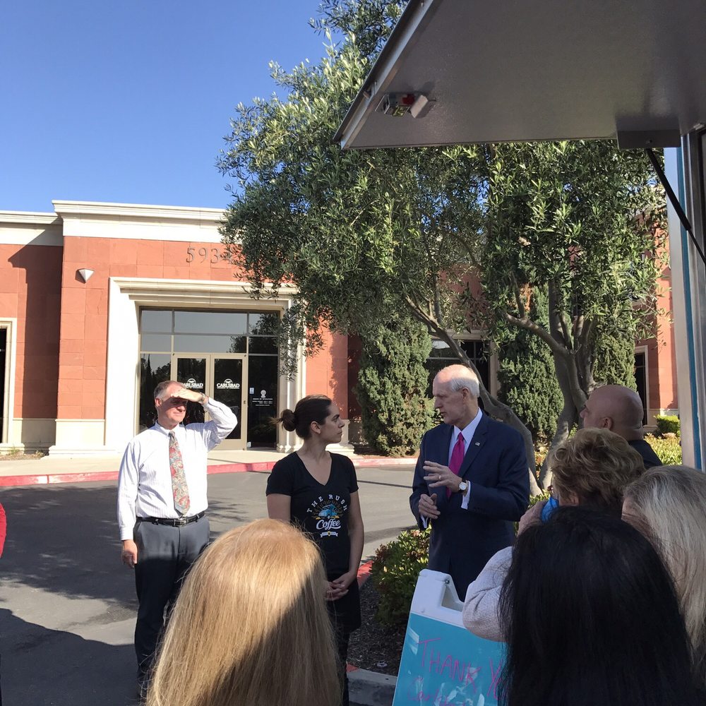 The Rush Coffee - President & CEO of the Carlsbad Chamber of Commerce welcoming owner Claire to the chamber. - Coffee & Tea Near Me The Rush Coffee - President & CEO of the Carlsbad Chamber of Commerce welcoming owner Claire to the chamber. - Coffee & Tea Near Me
