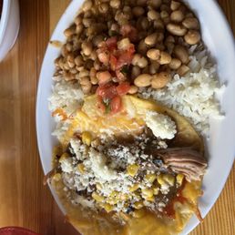 Fuego carnitas taco with white rice and Cajun beans