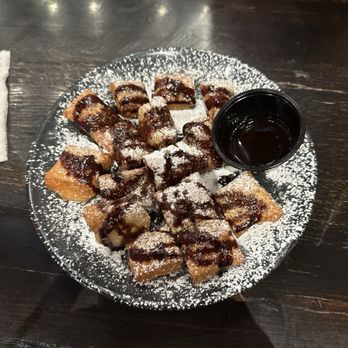 Walk-On’s Sports Bistreaux - La Porte, TX - Beignet Bites with chocolate syrup - Sports Bars Near Me - La Porte, Texas Walk-On’s Sports Bistreaux - La Porte, TX - Beignet Bites with chocolate syrup - Sports Bars Near Me - La Porte, Texas