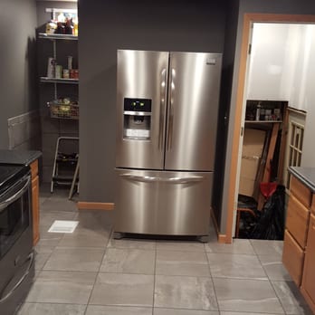 Longs Construction - a stainless steel refrigerator in a kitchen - Roofing Near Me Longs Construction - a stainless steel refrigerator in a kitchen - Roofing Near Me