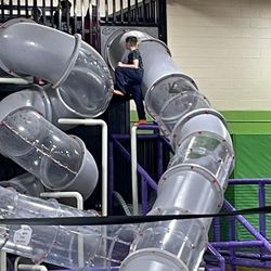 Fun City Trampoline Park - Kid climbing to the top outside of the safety netting. Not an employee in sight! He was probably 25 ft up.