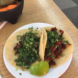 a plate of tacos and a bowl of pickles a plate of tacos and a bowl of pickles