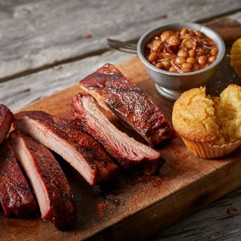 Famous Dave's - Joplin - ribs and corn on a cutting board - Barbeque Near Me - Joplin, Missouri Famous Dave's - Joplin - ribs and corn on a cutting board - Barbeque Near Me - Joplin, Missouri