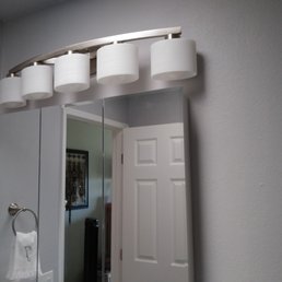 a bathroom with a large mirror a bathroom with a large mirror