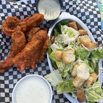 Black Market Bar & Grill - Phil's Fingers tossed in halo the horrible sauce with a side Caesar salad - Bars Near Me - Birmingham, Alabama Black Market Bar & Grill - Phil's Fingers tossed in halo the horrible sauce with a side Caesar salad - Bars Near Me - Birmingham, Alabama