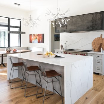 Timeless Interiors - a modern kitchen with a large island - Flooring Near Me - Lakeway, Texas