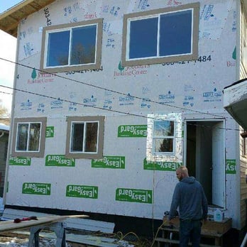 Adept Contracting - a man standing in front of a house under construction - General Contractors Near Me Adept Contracting - a man standing in front of a house under construction - General Contractors Near Me