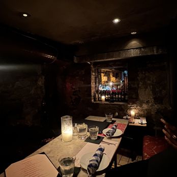 Shalel - a dimly lit bar with candles and menus - Moroccan Near Me - New York, New York Shalel - a dimly lit bar with candles and menus - Moroccan Near Me - New York, New York
