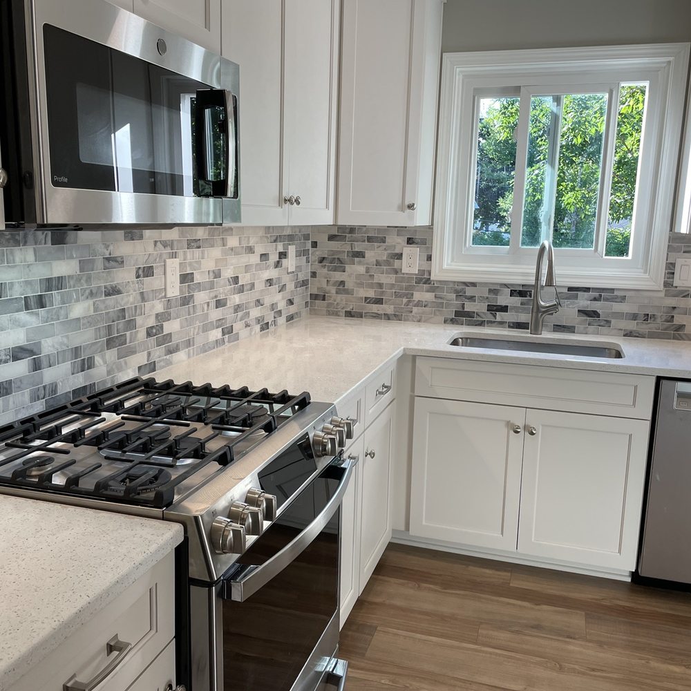 Anzalone Construction - a kitchen with white cabinets and stainless steel appliances - General Contractors Near Me - Aurora, Illinois