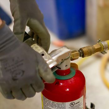 Weber & Troseth - Technician applying pressurized nitrogen to refill the extinguisher. - Fire Protection Services Near Me - Saint Paul, Minnesota Weber & Troseth - Technician applying pressurized nitrogen to refill the extinguisher. - Fire Protection Services Near Me - Saint Paul, Minnesota