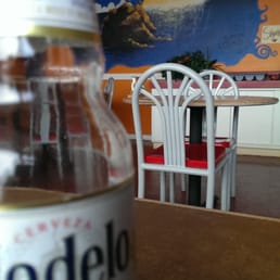 a bottle of modelo beer on a table