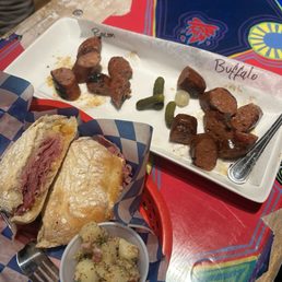 Reuben, potato salad, and sausage platter Reuben, potato salad, and sausage platter