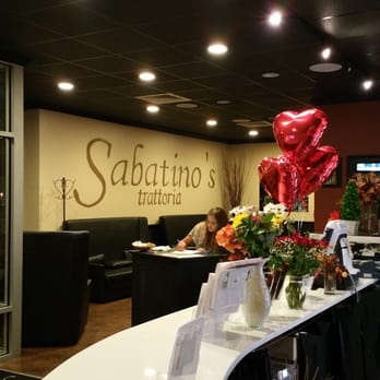 Sabatino's Trattoria - a woman sitting at a table - Italian Near Me - Norton, Massachusetts Sabatino's Trattoria - a woman sitting at a table - Italian Near Me - Norton, Massachusetts