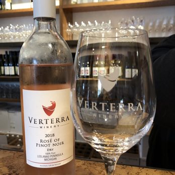 Verterra Winery - a bottle of rose wine next to a wine glass - Wineries Near Me - Leland, Michigan