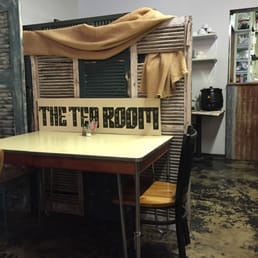 a table and chairs with a sign on it
