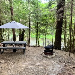 Dawleys Sol Duc River Campground - Site 18 drive up, river view with drop down platform for view of the river. Park and tents up above.