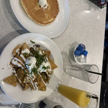 Broken Yolk Cafe - Chiliquilas with carne asada and a butter milk pancake. Fresh coffee and OJ - Breakfast & Brunch Near Me - Oceanside, California Broken Yolk Cafe - Chiliquilas with carne asada and a butter milk pancake. Fresh coffee and OJ - Breakfast & Brunch Near Me - Oceanside, California