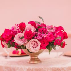 Studio Wildflower - The short centerpieces in addition to the tall ones, created a more visually appealing design to the wedding.