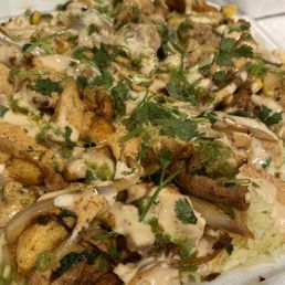 Somali rice with grilled chicken topped with onions, peppers, corn, cilantro, and three sauces (SW ranch, green chili, fav sauce). Somali rice with grilled chicken topped with onions, peppers, corn, cilantro, and three sauces (SW ranch, green chili, fav sauce).