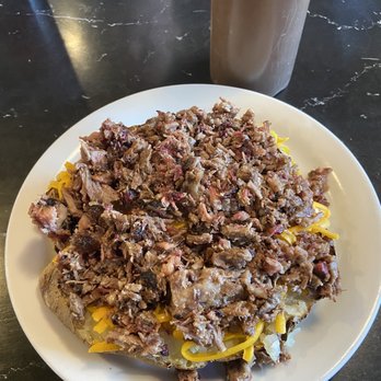 Red River BBQ and Grill - Appeal shot of Beef Brisket loaded Spud - Potato with Sauce ready! - Barbeque Near Me - Katy, Texas Red River BBQ and Grill - Appeal shot of Beef Brisket loaded Spud - Potato with Sauce ready! - Barbeque Near Me - Katy, Texas