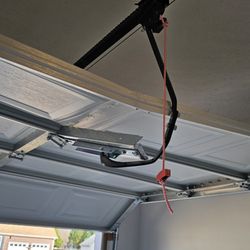 Lion Garage Door - Glue used to hold the panel that was connected to the arm that pulls the garage door open and shut.