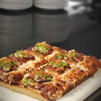 J. Beethoven's Pizza - a slice of pizza on a cutting board - Pizza Near Me - Chilliwack, British Columbia