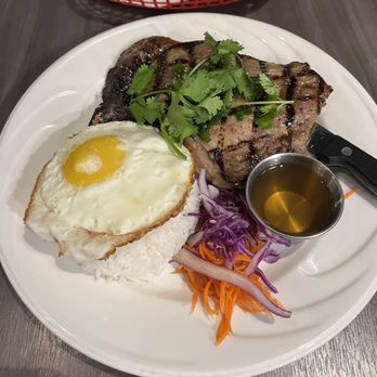 Saigon District Restaurant Presotea - Signature Grilled Pork Chops - doesn't look like a lot of meat but there is a lot more underneath - Vietnamese Near Me - Huntington Beach, California Saigon District Restaurant Presotea - Signature Grilled Pork Chops - doesn't look like a lot of meat but there is a lot more underneath - Vietnamese Near Me - Huntington Beach, California