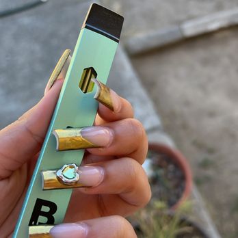 The Nail Files - Gold French tip with Leo birthstone charm - Nail Technicians Near Me - Fresno, California The Nail Files - Gold French tip with Leo birthstone charm - Nail Technicians Near Me - Fresno, California