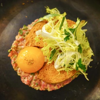 Spoon and Stable - Bison Tartare-
cornichons, herb salad, chicken egg yolk - New American Near Me - Minneapolis, Minnesota Spoon and Stable - Bison Tartare-
cornichons, herb salad, chicken egg yolk - New American Near Me - Minneapolis, Minnesota