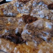 Photo of The Blind Horse Restaurant - Kohler, WI, United States. Grilled flatbread of braised pulled pork, onions, provolone