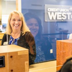 Credit Union West - Branch manager greeting member at the teller line at Credit Union West Branch in Surprise.