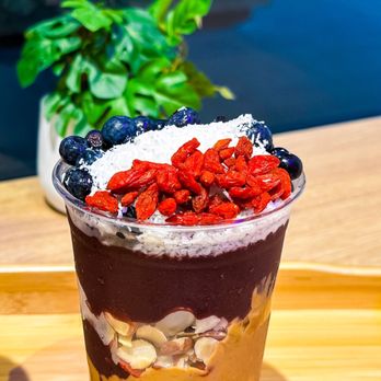 Oakberry Acai - a smoothie in a plastic cup on a wooden table - Acai Bowls Near Me - Huntington Beach, California