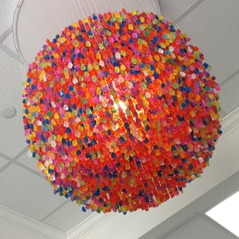 Giggles - a multicolored chandelier hanging from the ceiling - Candy Stores Near Me - Baton Rouge, Louisiana