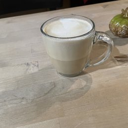 a cup of coffee on a table a cup of coffee on a table