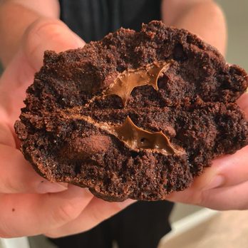 Taming Turtle Cookies - a person holding a chocolate cookie - Desserts Near Me Taming Turtle Cookies - a person holding a chocolate cookie - Desserts Near Me