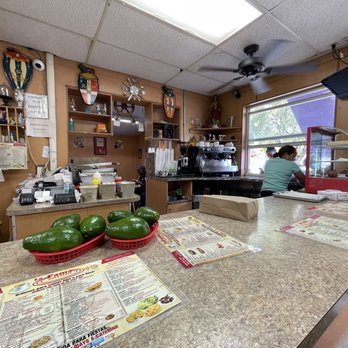 La Famosa Cafeteria - a counter with menus on it - Cuban Near Me - Miami, Florida La Famosa Cafeteria - a counter with menus on it - Cuban Near Me - Miami, Florida