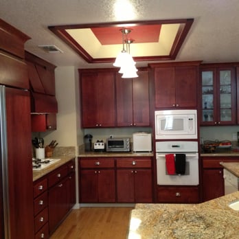 The Cabinet Doctors - Cherry wood kitchen cabinets - resurfacing project included refrigerator door panels and matching trim around the light box - Cabinetry Near Me - Rocklin, California
